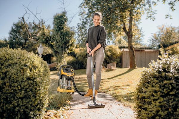 Prikaz ženske, ki ureja vrtno površino s namenskim sesalnikom Kärcher